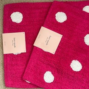 Two Kate Spade hot pink polka dot bathroom rugs